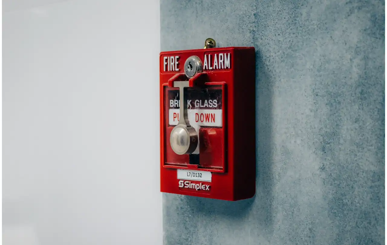 Fire alarm pull station mounted on wall, representing commercial fire alarm systems where 14 AWG fire systems wire supports reliable signal and power distribution