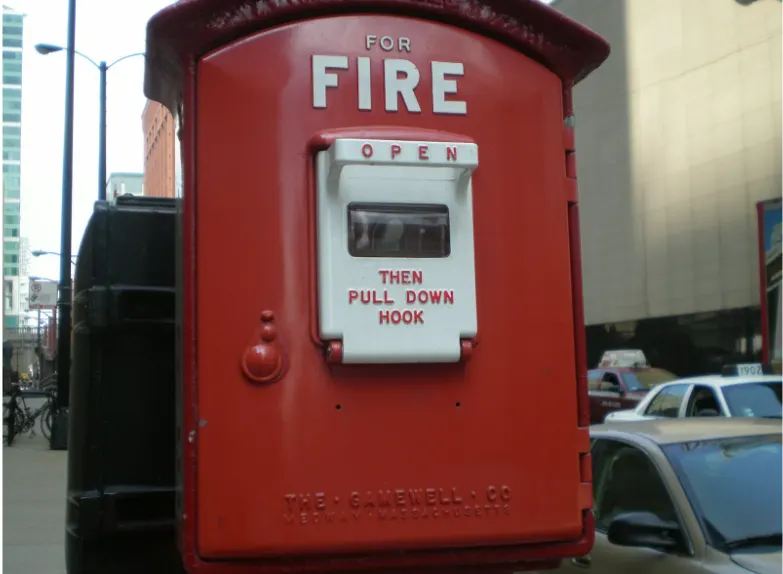 Red street fire alarm call box illustrating life safety emergency signaling infrastructure related to circuit integrity and 2-hour fire cable systems