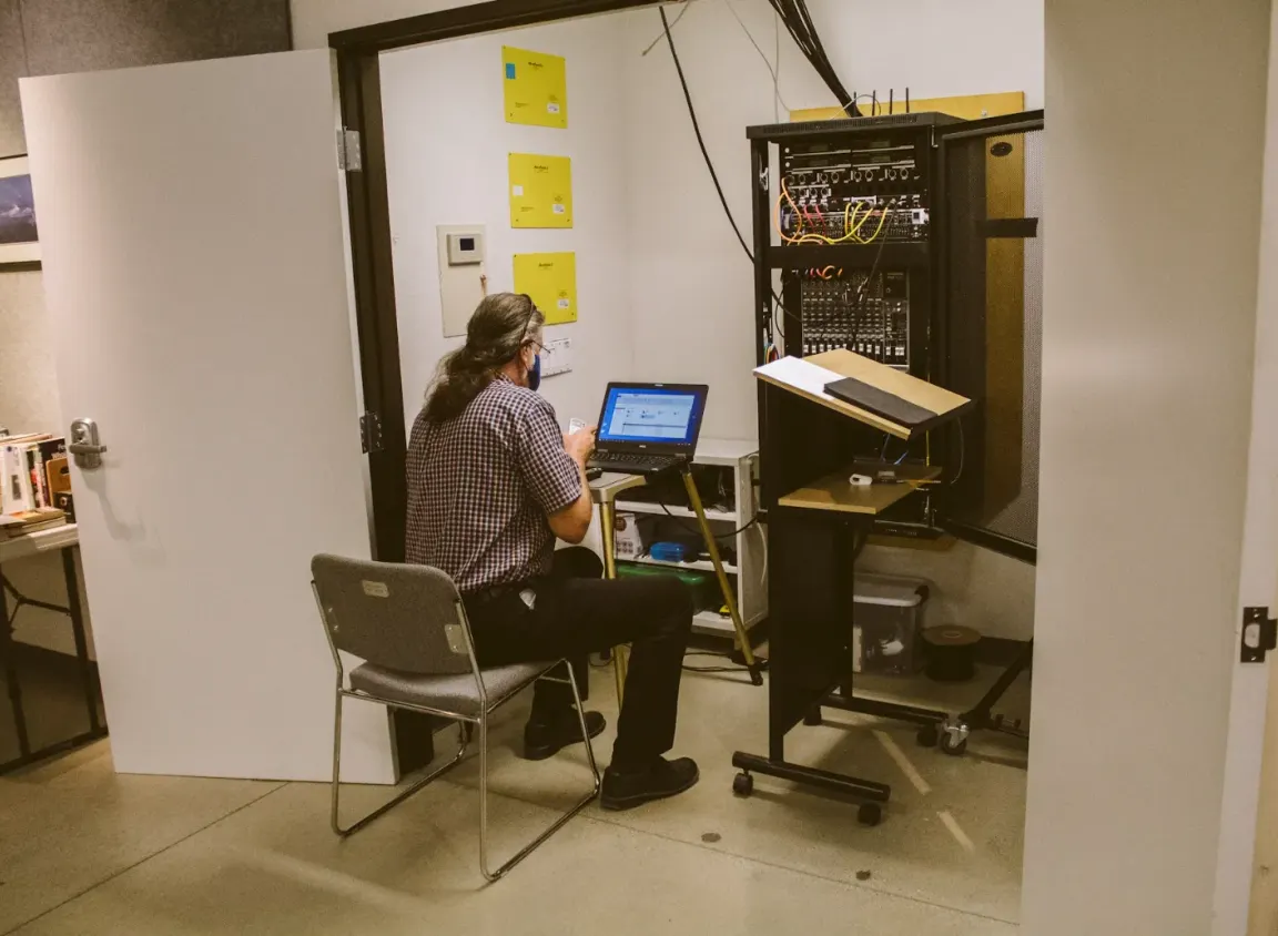 Network technician configuring a commercial structured cabling rack with Ethernet switches and patch panels to support Cat5e, Cat6, and Cat6a network infrastructure.