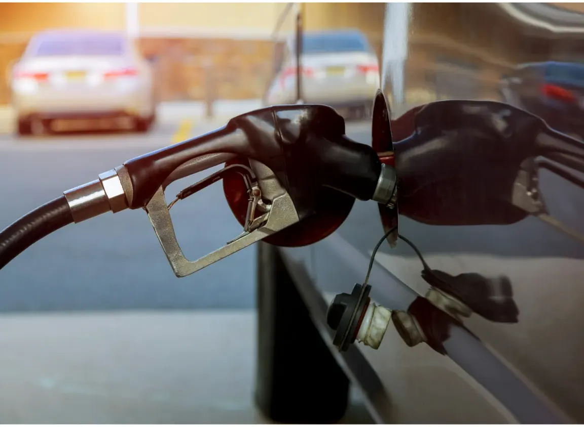 Fuel dispenser nozzle at a commercial gas station representing petroleum environments where FEP Category 5e cables support forecourt communication and monitoring systems