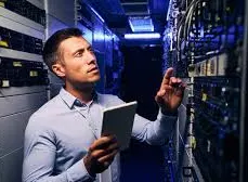 AV integrator reviewing installed components on a server rack