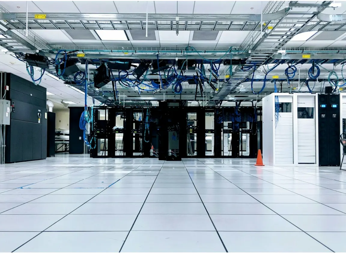 Data center with structured cabling and overhead fiber pathways illustrating enterprise network infrastructure using OM1 vs OM3 multimode fiber and pre-terminated fiber optic cable systems